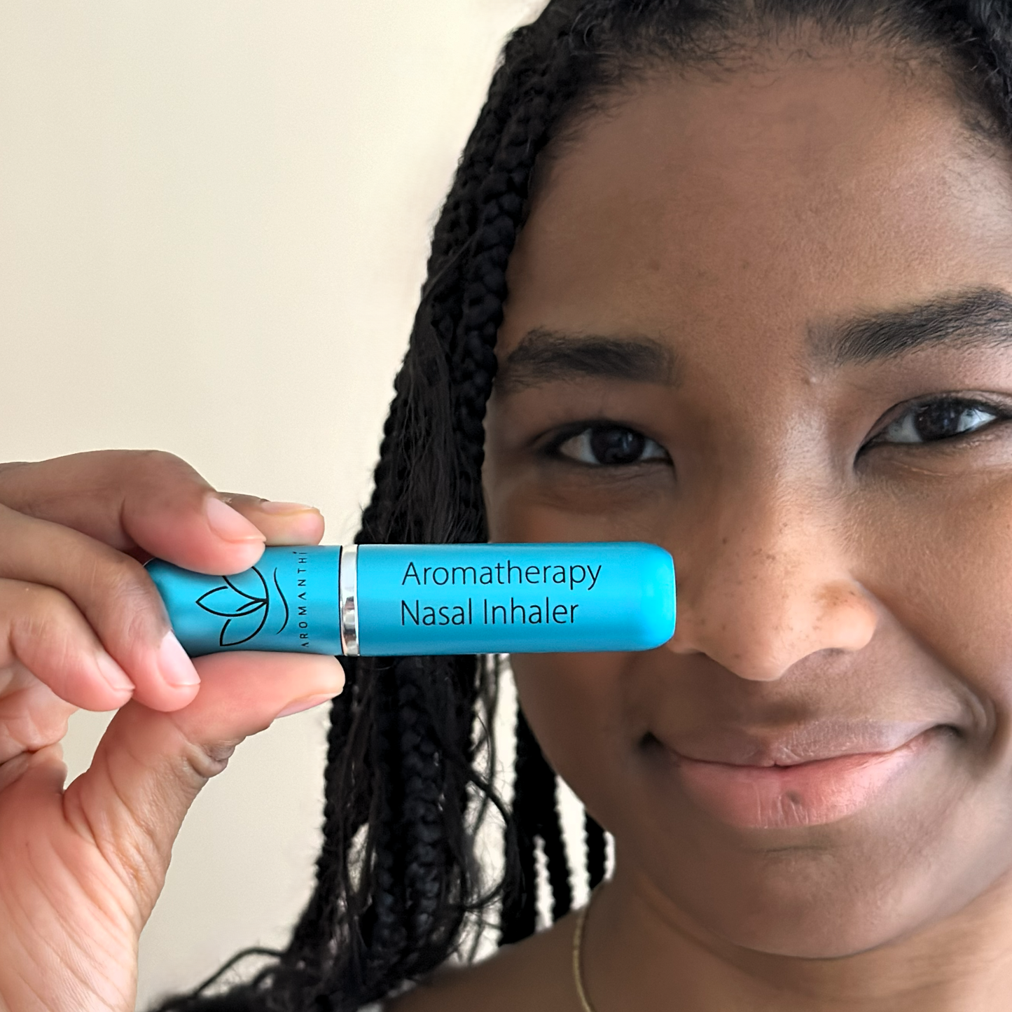 Woman holding a blue aromatherapy inhaler stress relief blend