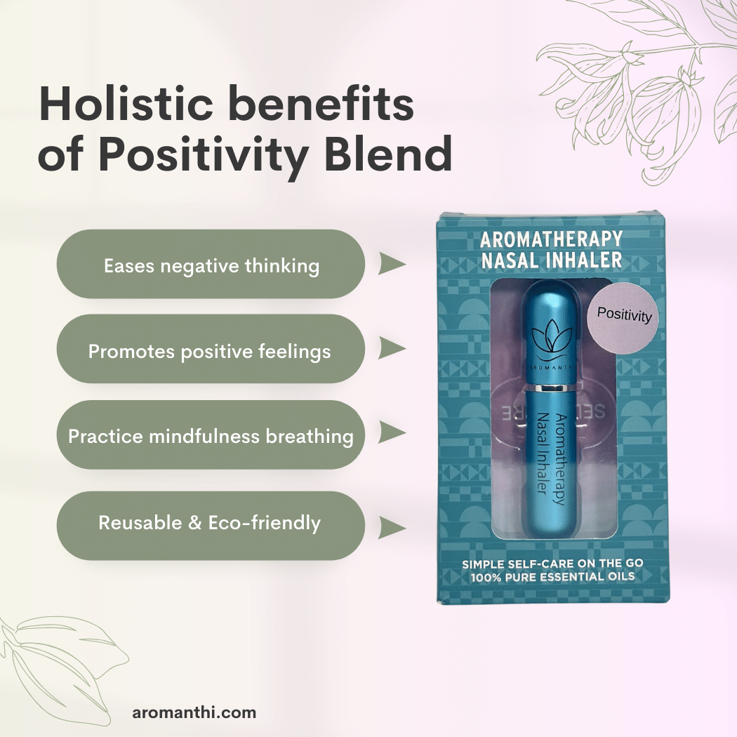 A pink background with an image of the blue positivity aromatherapy nasal inhaler and text that states holistic benefits of balance blend eases negative thinking, promotes positive feelings, practice mindfulness breathing, reusable and eco friendly
