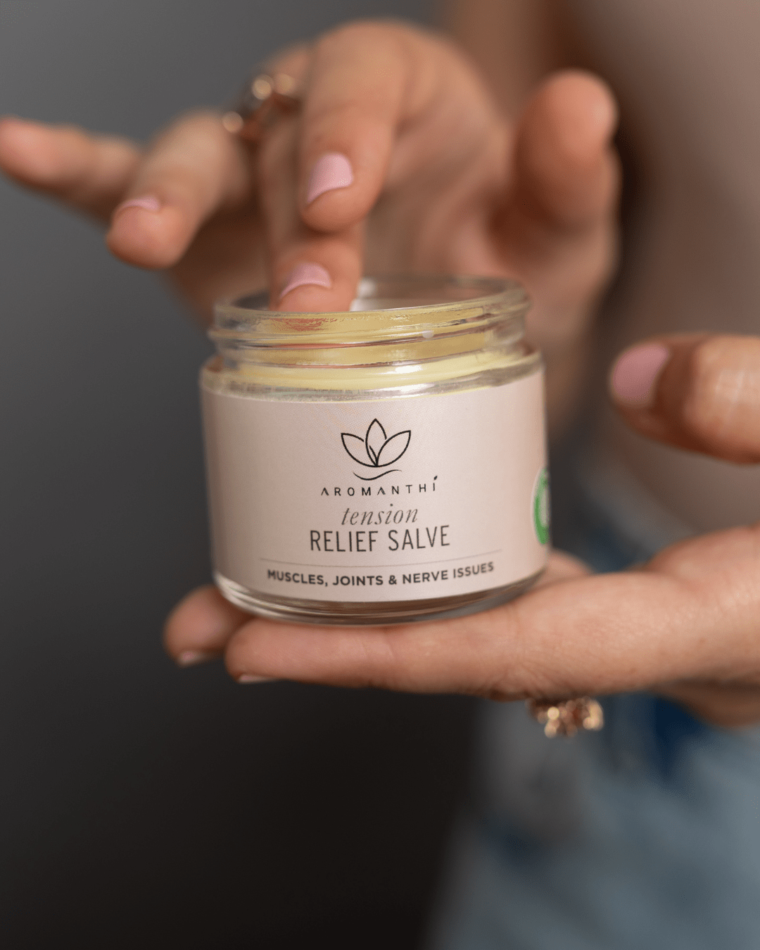 A pain salve by Aromanthi to relieve tension for muscles, joint and nerve issues. Made with essential oil and all natural organic ingredients like coconut oil, jojoba oil, rosewater, beeswax and rosemary oil, frankincense oil.